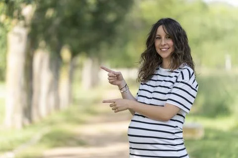 Photo with copy space to insert something with a pregnant woman pointing Stock Photos