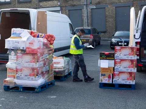 Photo of Delivery driver checking goods. Editorial use only. Stock Photos