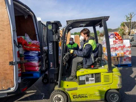 Photo of Delivery drivers loading van. Editorial use only. Stock Photos