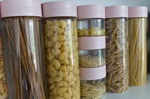 Photo of different pasta types in plastic jars Stock Photos