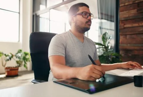 Photo editor using graphics tablet in office Stock Photos