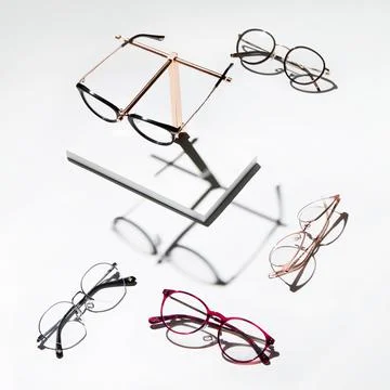 Photo of eye glasses of different frames isolated on a white surface Stock Photos