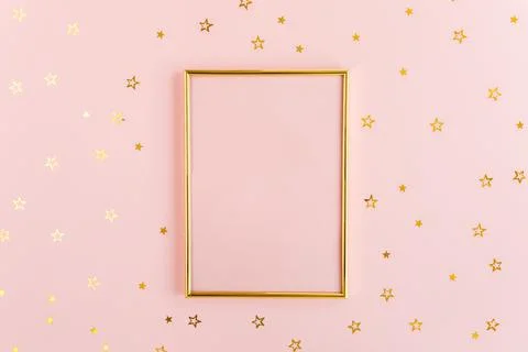 Photo frame mock up with space for text, golden confetti on a pink background Stock Photos