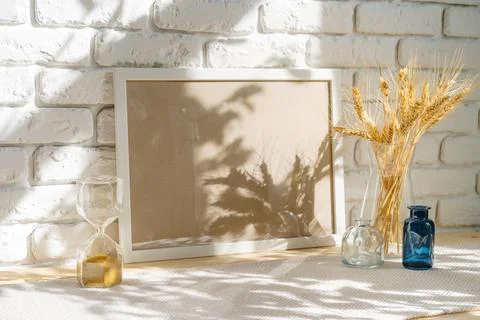 Photo frames on a brick wall background on the table with wheat ears in vase Stock Photos