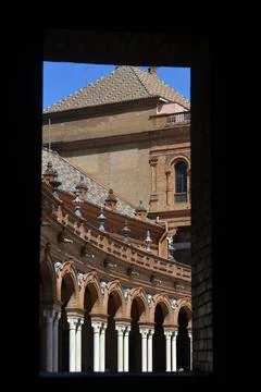 A photo frames a section of a Spanish building with a tiled roof. The buildin Stock Photos