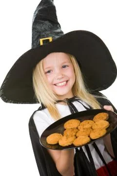 Photo of girl in halloween costume holding tray with bisquits Stock Photos