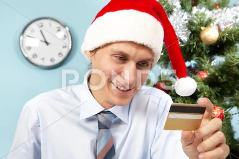 Photo of happy santa claus looking at plastic card in his hand Stock Photos