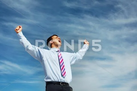 Photo of happy winner screaming from joy on background of blue summer sky Stock Photos