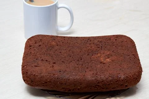 Photo Humble pie (bread) on the table with a mug of tea Stock Photos