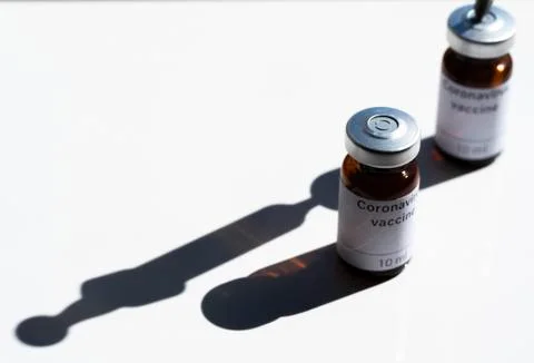 In this photo illustration two vials labelled Coronavirus vaccine and syringe Stock Photos