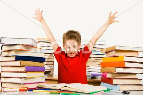 Photo of joyful pupil raising arms in excitement and looking at camera with smil Stock Photos