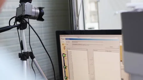 The photo lab operator sets up the printing of photos on the computer. Stock Footage 303410495