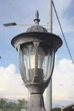 A photo of a lamp post installed at the front gate wall Stock Photos