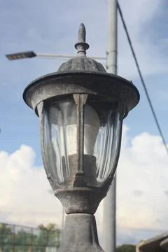 A photo of a lamp post installed at the front gate wall Stock Photos