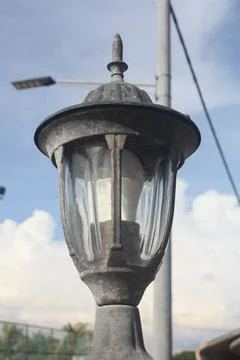 A photo of a lamp post installed at the front gate wall Stock Photos