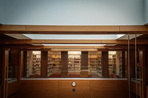 Photo of library with clock on the wall Stock Photos