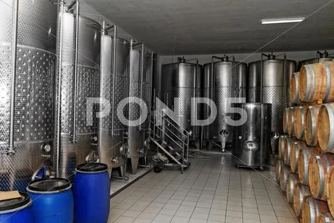 Photo of modern aluminum barrels in the winery Stock Photos