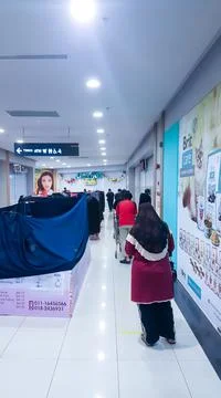 A photo of people queue inside Tesco Bandar Puteri shopping mall. Stock Photos