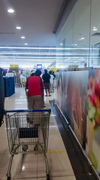 A photo of people queue inside Tesco Bandar Puteri shopping mall. Stock Photos