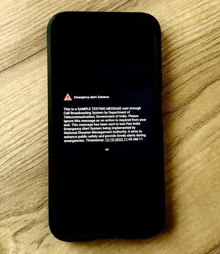 Photo of a phone displayed with a sample testing message Stock Photos