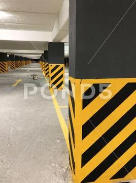 Photo of a potential danger diagonal stripes on a column in a car park. Stock Photos