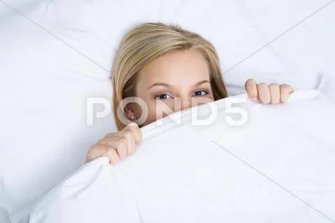 Photo of pretty woman peeping out of white linen Stock Photos