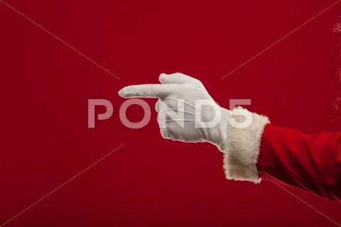 Photo of Santa Claus gloved hand in pointing gesture. fingers Stock Photos