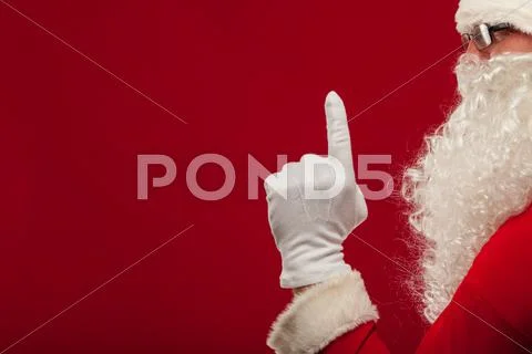 Photo of Santa Claus gloved hand in pointing gesture. fingers Stock Photos