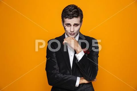 Photo of scary zombie fiance on halloween wearing classical suit and creepy m Stock Photos