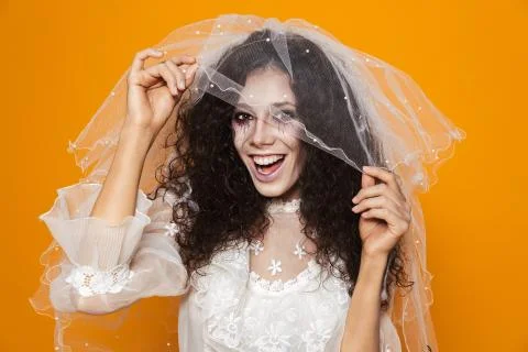 Photo of scary zombie woman on halloween wearing wedding dress and holiday ma Stock Photos