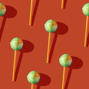 Photo seamless pattern of candy on a stick with shadows on a colored orange Stock Illustration