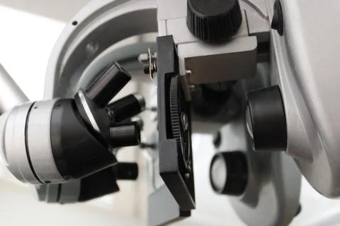 The photo shows a microscope. Stock Photos