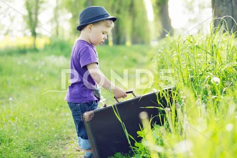 Photo of small kid trying to escape with suitcase Stock Photos