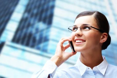 Photo of smart businesswoman calling somebody by mobile telephone Stock Photos