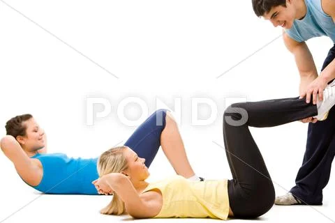 Photo of sportswomen doing physical exercise with help of instructor Stock Photos