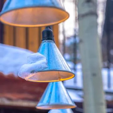 Photo Square Cone shaped string lights with snow hanging outside a home in Foto stock