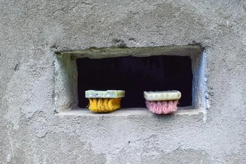 Photo of a square wall ventilation with two brushes there Stock Photos