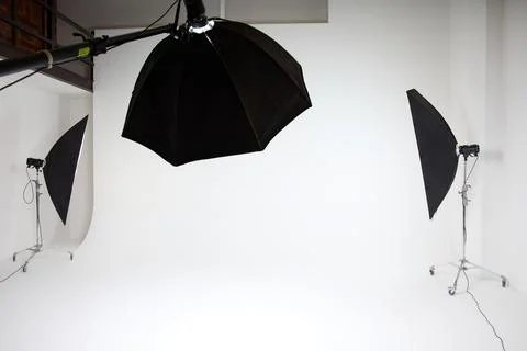 Photo studio inside, white background, several racks with light sources Stock Photos