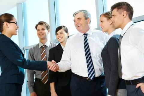Photo of successful associates handshaking after striking deal with partners nea Stock Photos