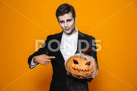 Photo of terrifying dead man on halloween wearing classical suit and creepy m Stock Photos