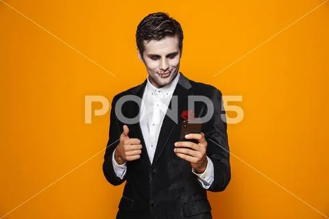 Photo of terrifying dead man on halloween wearing classical suit and creepy m Stock Photos
