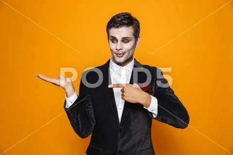 Photo of terrifying zombie bridegroom wearing classical suit and halloween ma Stock Photos