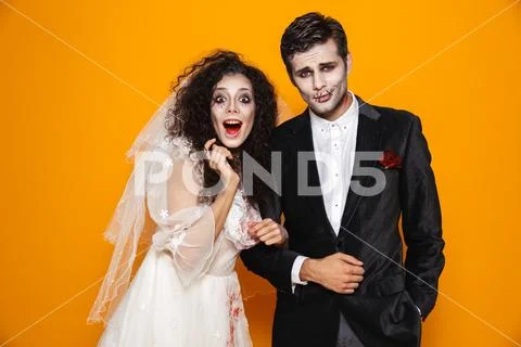Photo of terrifying zombie couple bridegroom and bride wearing wedding outfit Stock Photos