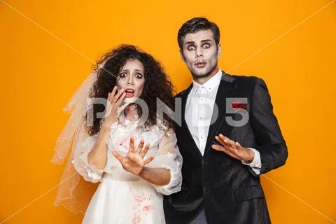 Photo of terrifying zombie couple bridegroom and bride wearing wedding outfit Stock Photos
