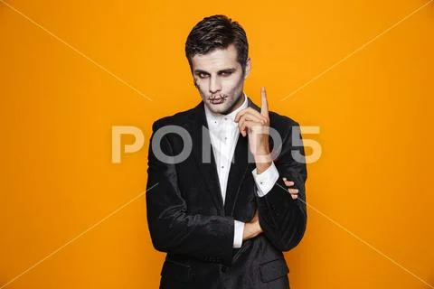Photo of terrifying zombie gentleman on halloween wearing classical suit and Stock Photos
