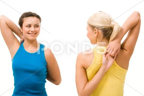 Photo of two pretty friends having a chat during workout in gym Stock Photos