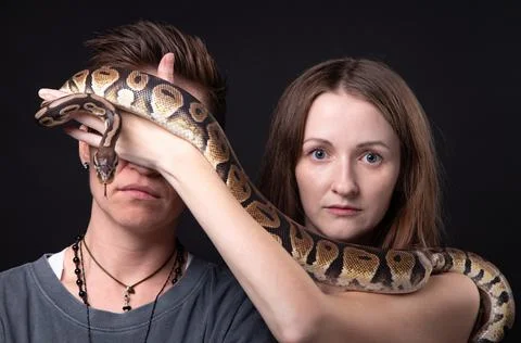 Photo of two women with python on closed eyes Photos
