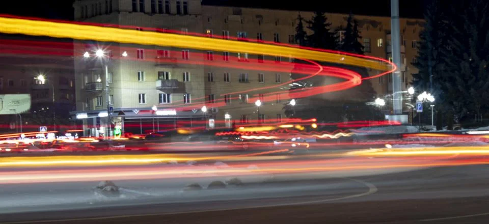A photo using a slow shutter speed to capture the lights on a highway. Stock Photos