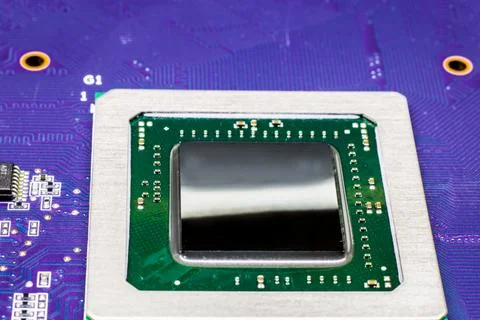 Photo of a video card processor surrounded by electrical connections. Stock Photos