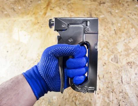 Photo of a worker hand with stapler. Stock Photos